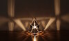 Alternate angle of KAGE's Tetrahedron Platonic Solid Lamp, showcasing the brilliance of its high-gloss polished stainless steel and fractal designs representing Fire.