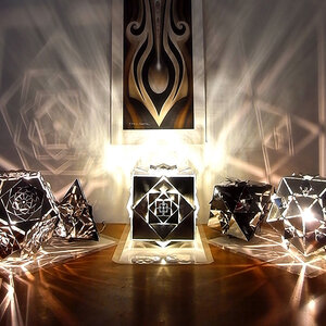 Platonic Solids Collection by KAGE: Lamps Illuminating the Darkness KAGE's collection of five lamps, brilliantly illuminated, casting intricate patterns of light and shadow in the darkness.